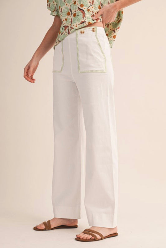 White pants with green seams