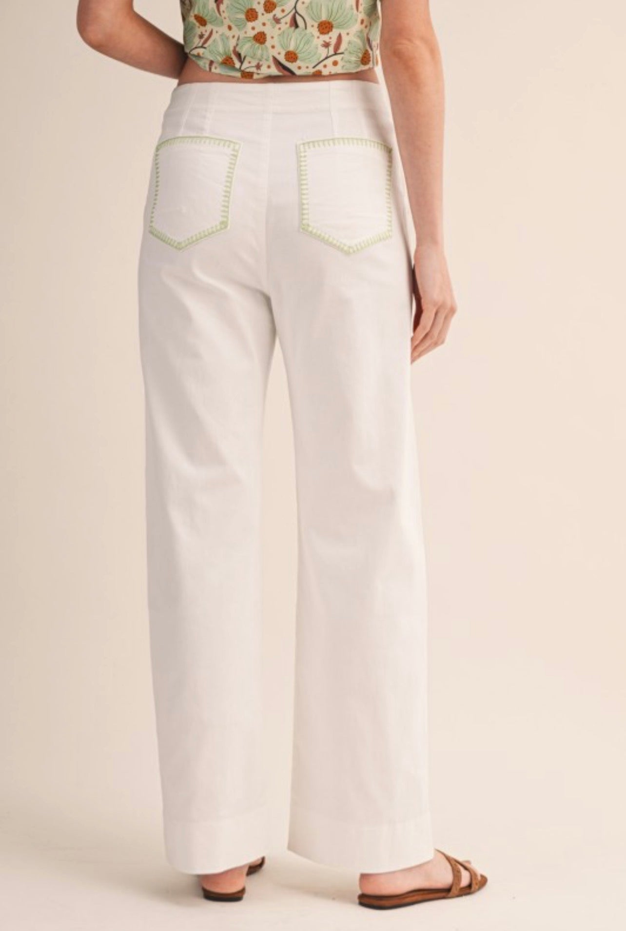 White pants with green seams